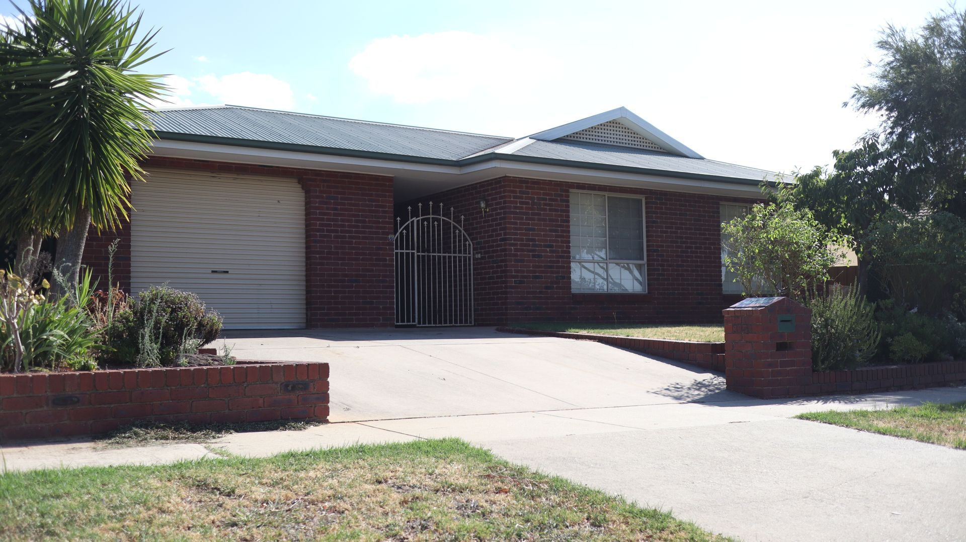Older face brick home with a concrete driveway  — Colombera Constructions In Wodonga, VIC