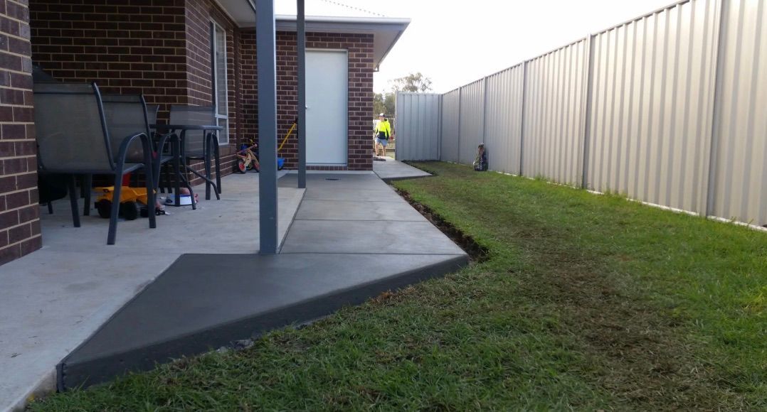 A Man Is Using A Machine To Polish A Black Floor — Colombera Constructions In Wodonga, VIC