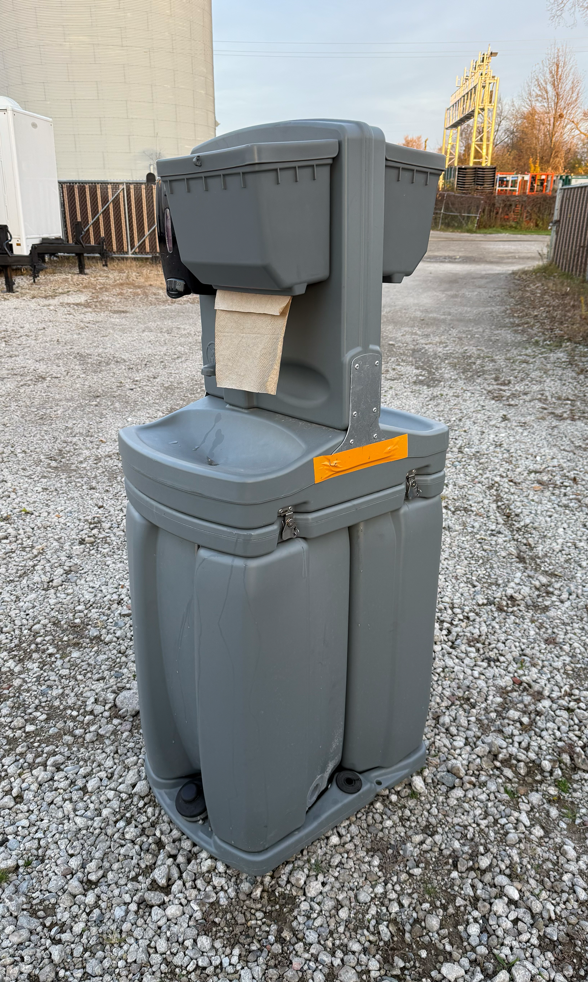 Blue mobile handwashing station with sinks, soap, and towel dispensers.
