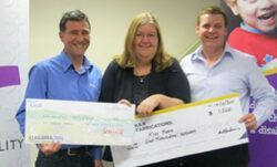 two men and a woman are holding checks in their hands