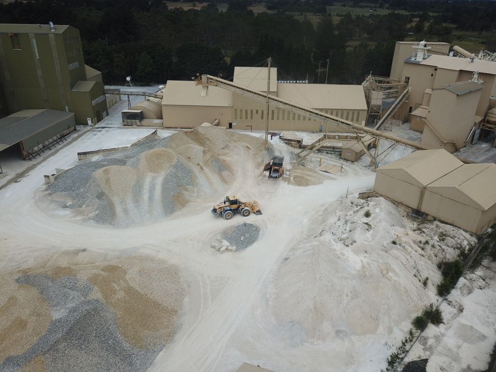 an aerial view of a factory with a lot of dirt and buildings