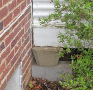 This sunroom addition was built on pre-cast concrete blocks and would not have passed an inspection.