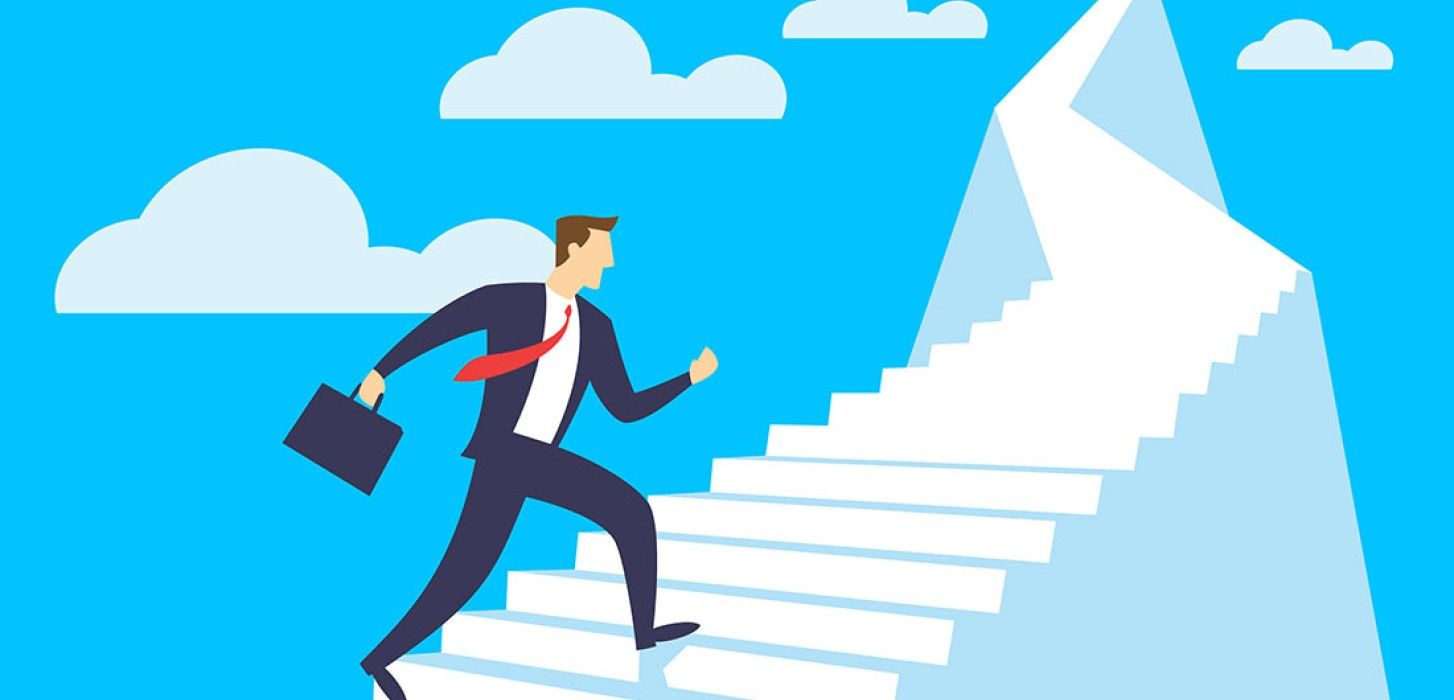 Businessperson climbing white stairs toward a mountain peak against a blue sky