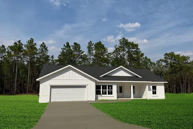 White single-story house with gray roof and attached garage beside a driveway and green lawn under a blue sky