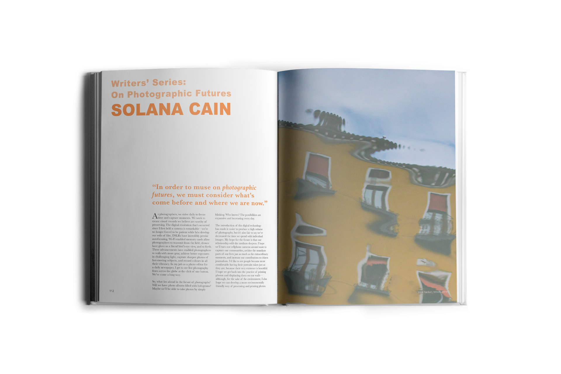 Open book with text and a colorful illustration of structures on a beach.