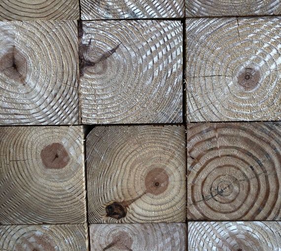 A close up of a stack of wooden blocks showing the grain of the wood.