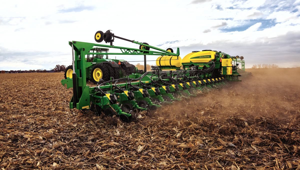 A tractor is spraying fertilizer on a field.