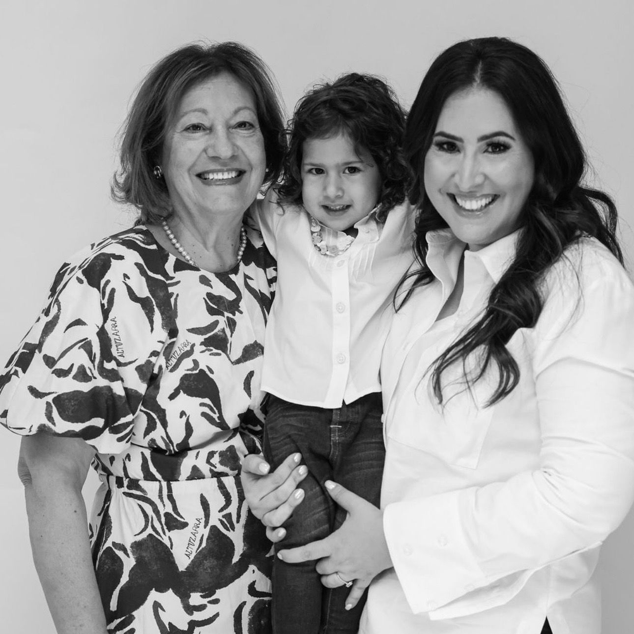 A black and white photo of two women and a child.