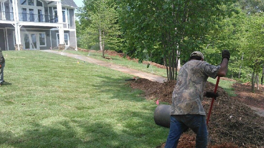 Man Cleaning the Soil Bed — Seneca, SC — Sheriff Landscaping