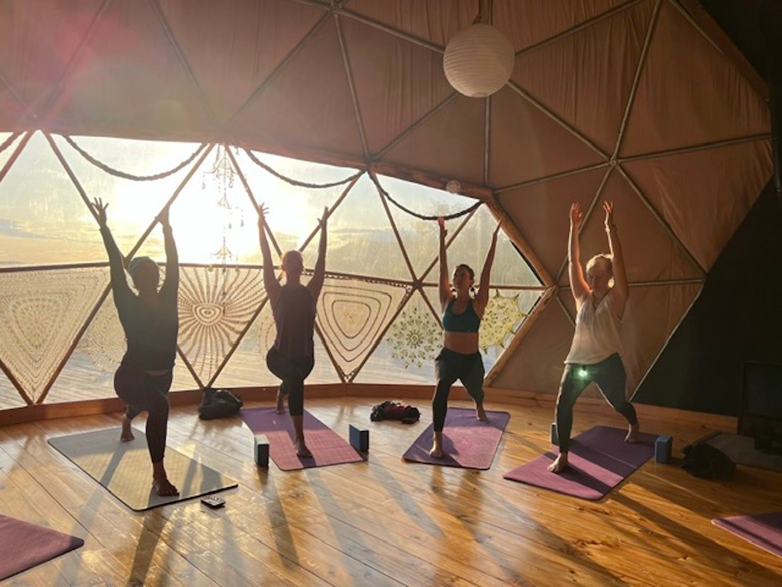 A group of women are doing yoga in a dome.