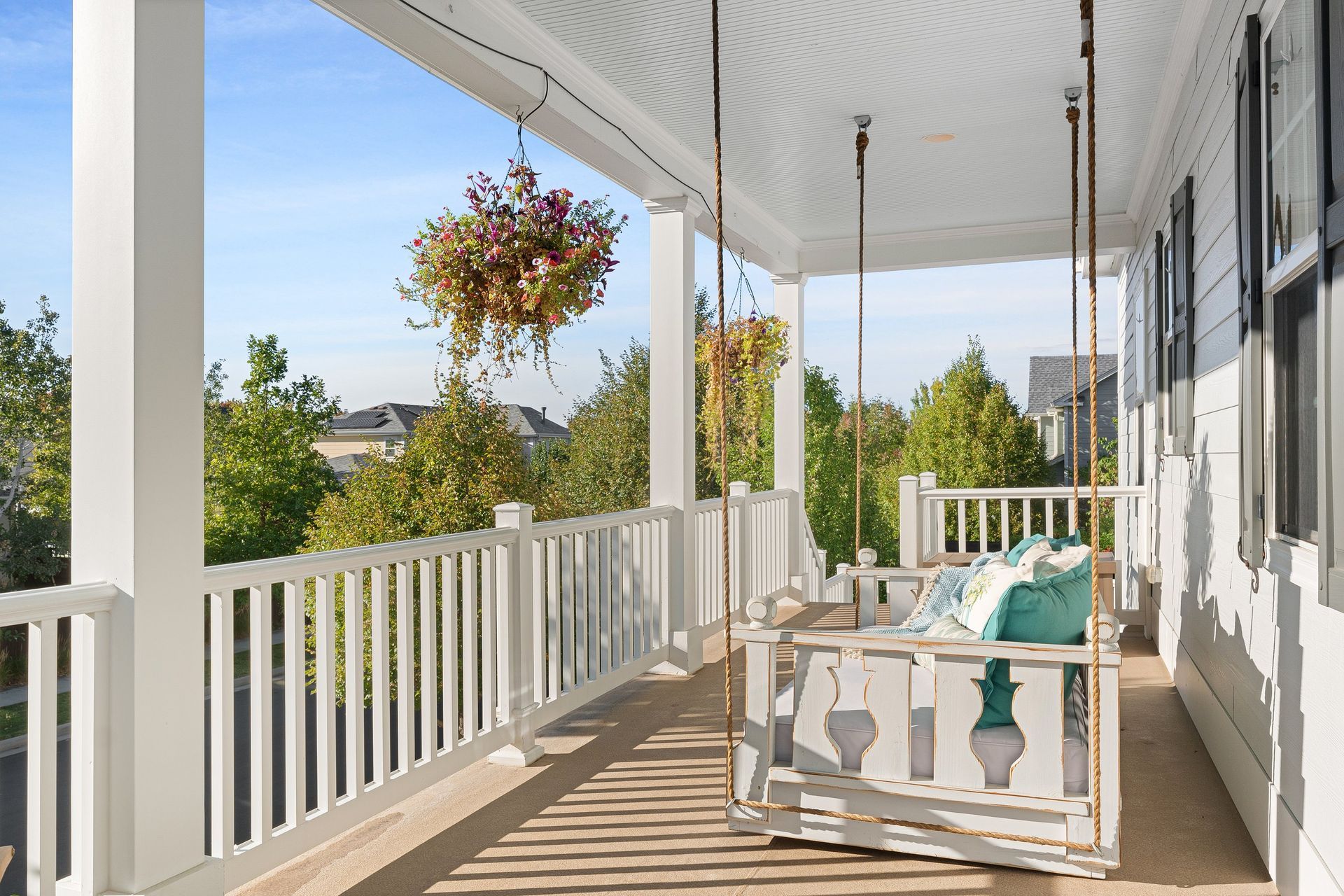 There is a porch swing on the porch of a house.