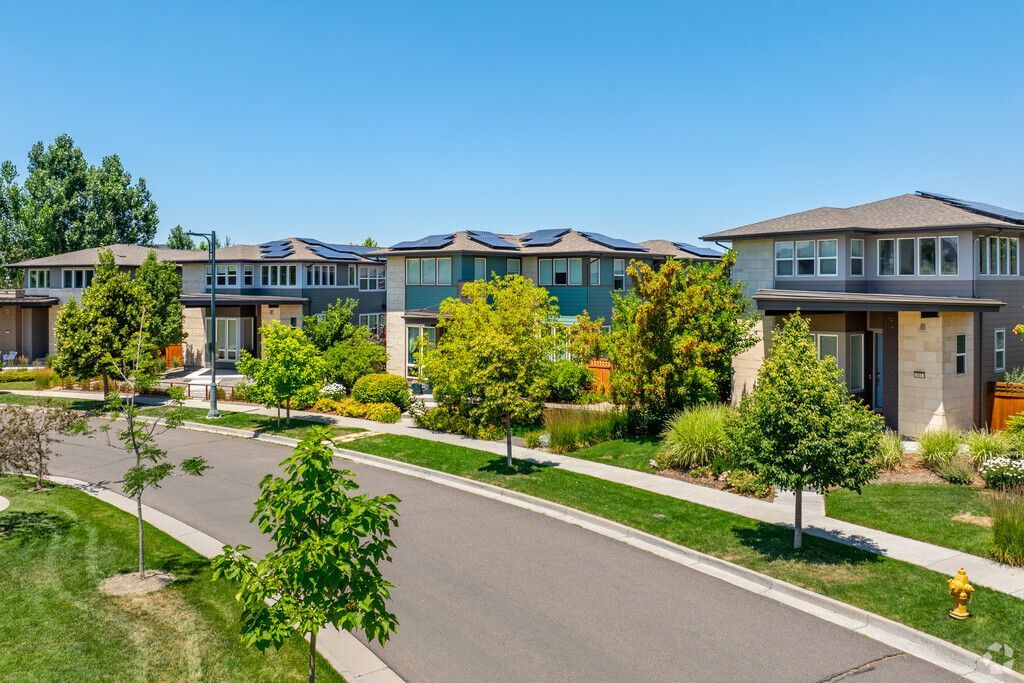 A row of houses are lined up on a sunny day in a residential neighborhood in Central Park Colorado.