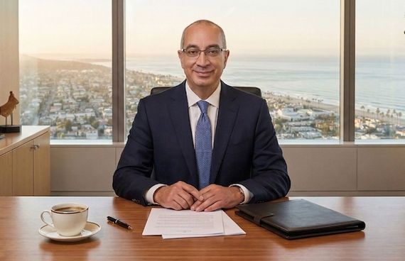 Nicholas Panos, Founder of Future Point Insurance Services Nicholas Panos seated at an executive desk in a professional office overlooking the coast