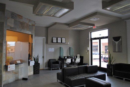 A waiting room with a couch and chairs in it | United Critical Care