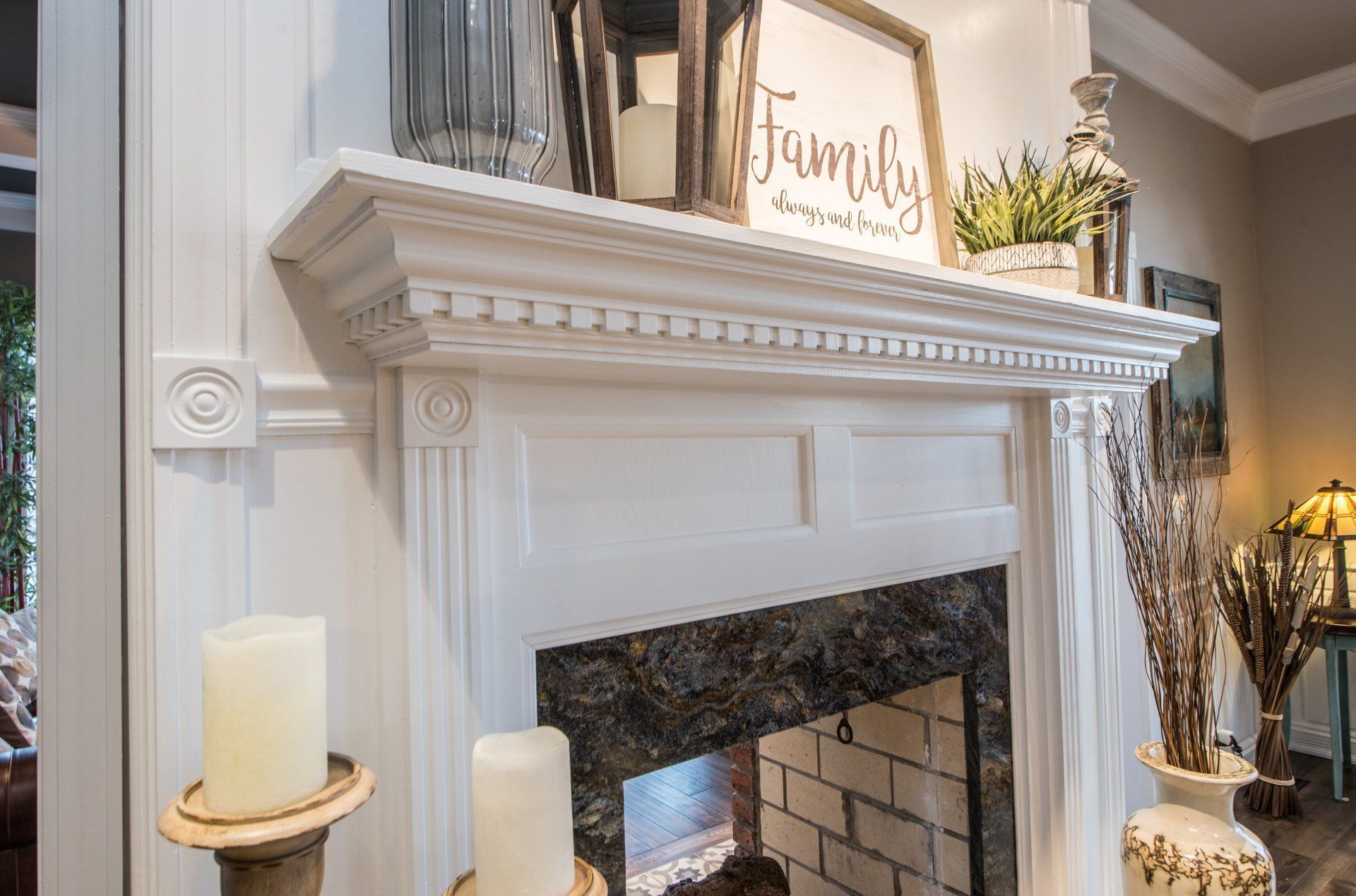 Elegant living room fireplace mantel with family sign, candles, and decor