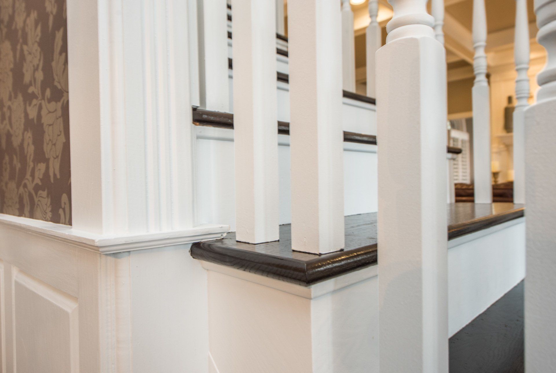 White columns and dark railings in an elegant interior staircase or balcony area