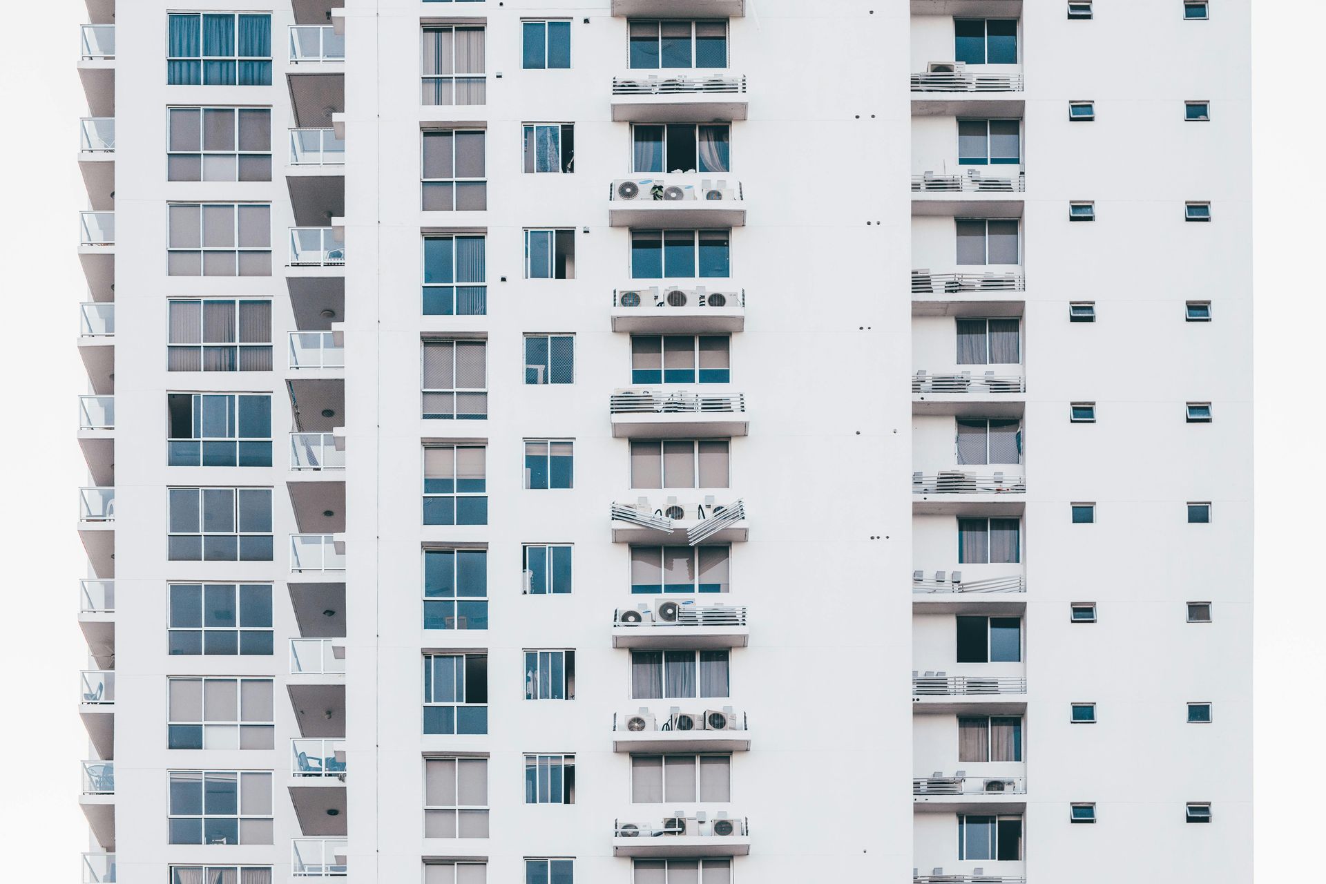 High-rise apartment building facade with balconies and blue-tinted windows