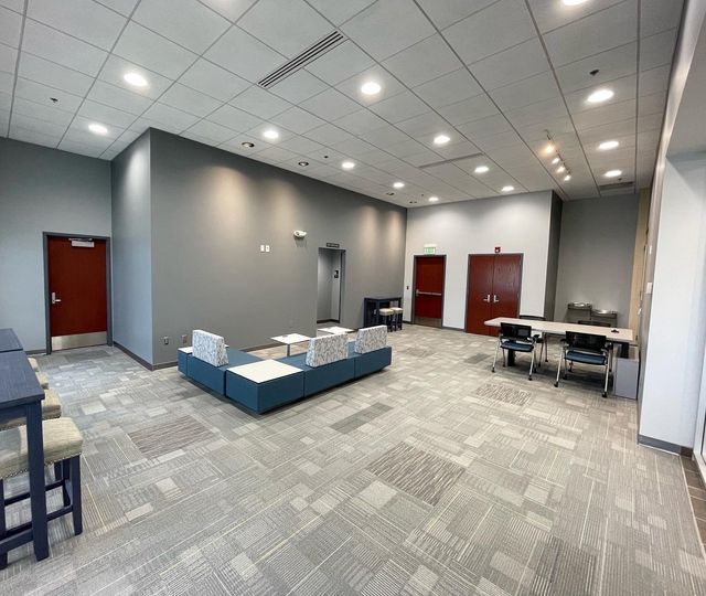 A large room with a lot of furniture and a lot of windows.