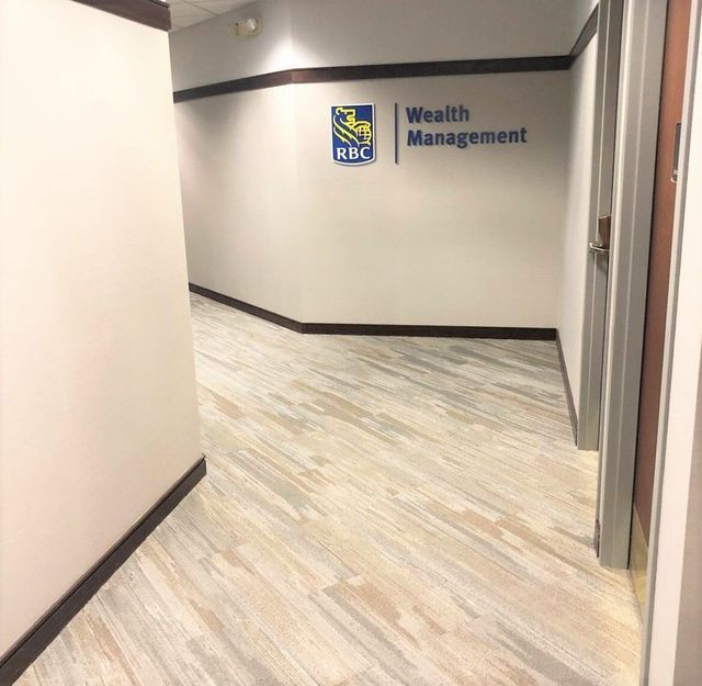 A hallway with a sign on the wall that says wealth management