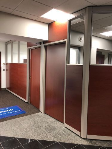 A hallway in an office building with a blue mat on the floor.