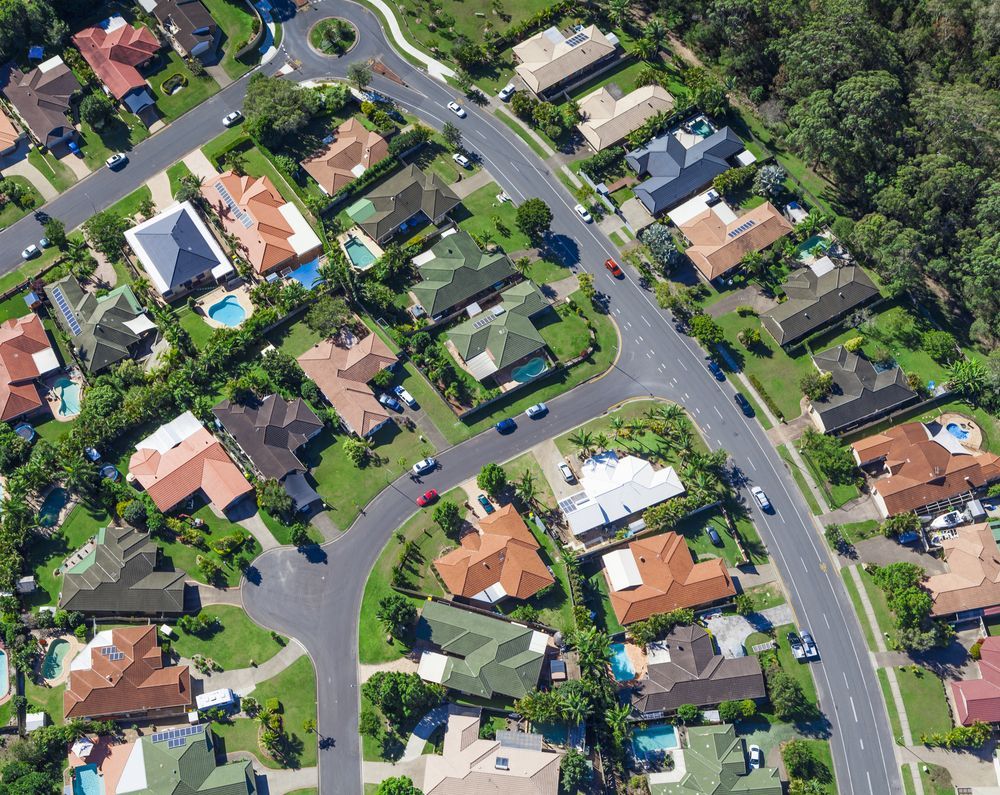 Suburban Neighborhood With Houses, Swimming Pools, Paved Streets, and Surrounding Trees — Gold Coast City Plumbing In Helensvale, QLD