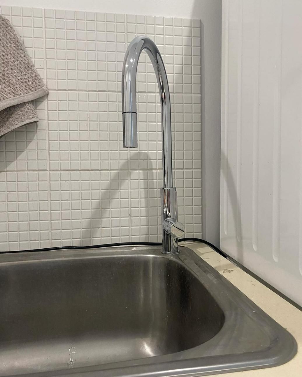 A Stainless Steel Kitchen Sink With A Chrome Faucet — Gold Coast City Plumbing In Helensvale, QLD