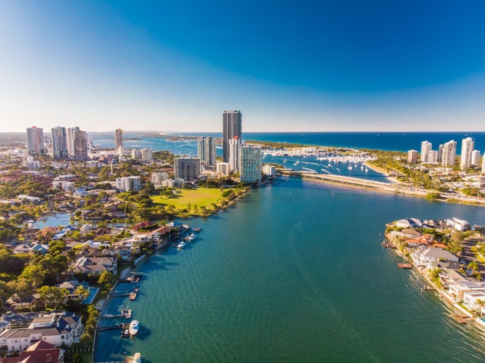 An Aerial View Of A City Surrounded By Water And Buildings — Gold Coast City Plumbing In Southport, QLD