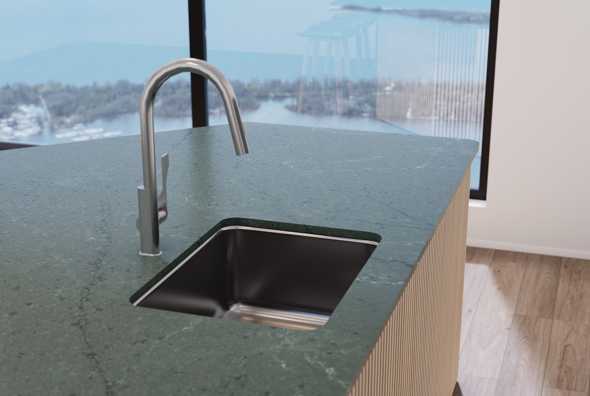Stainless steel sink and faucet on a green countertop with a view of a snowy landscape.