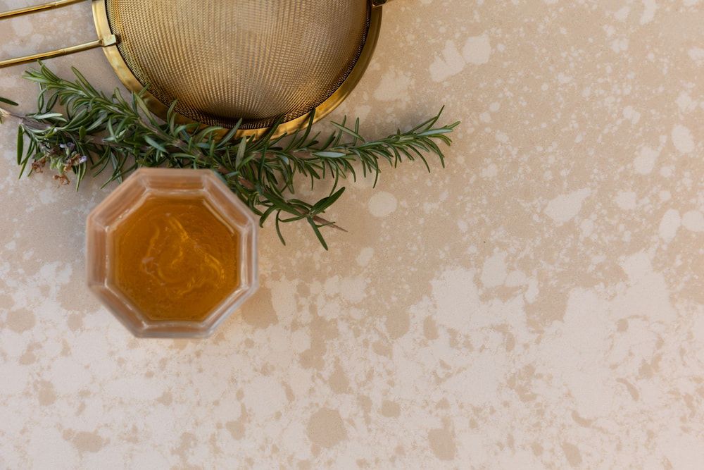 There is a Bowl of Honey and a Strainer on the Table — Better Stone in Caloundra West, QLD