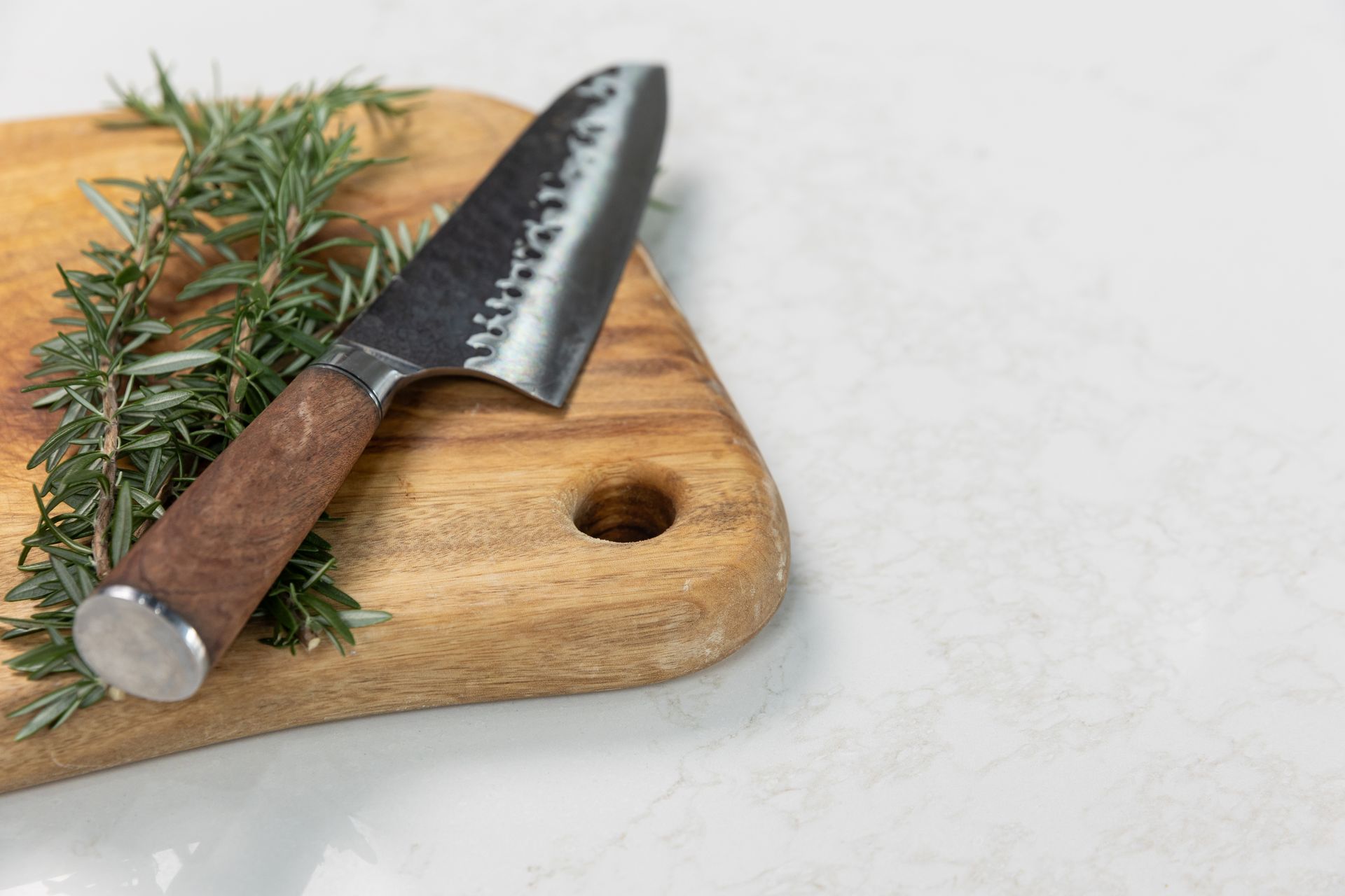 A Stainless Steel Kitchen Sink With a Copper Faucet on a White Counter Top — Better Stone in Caloundra West, QLD