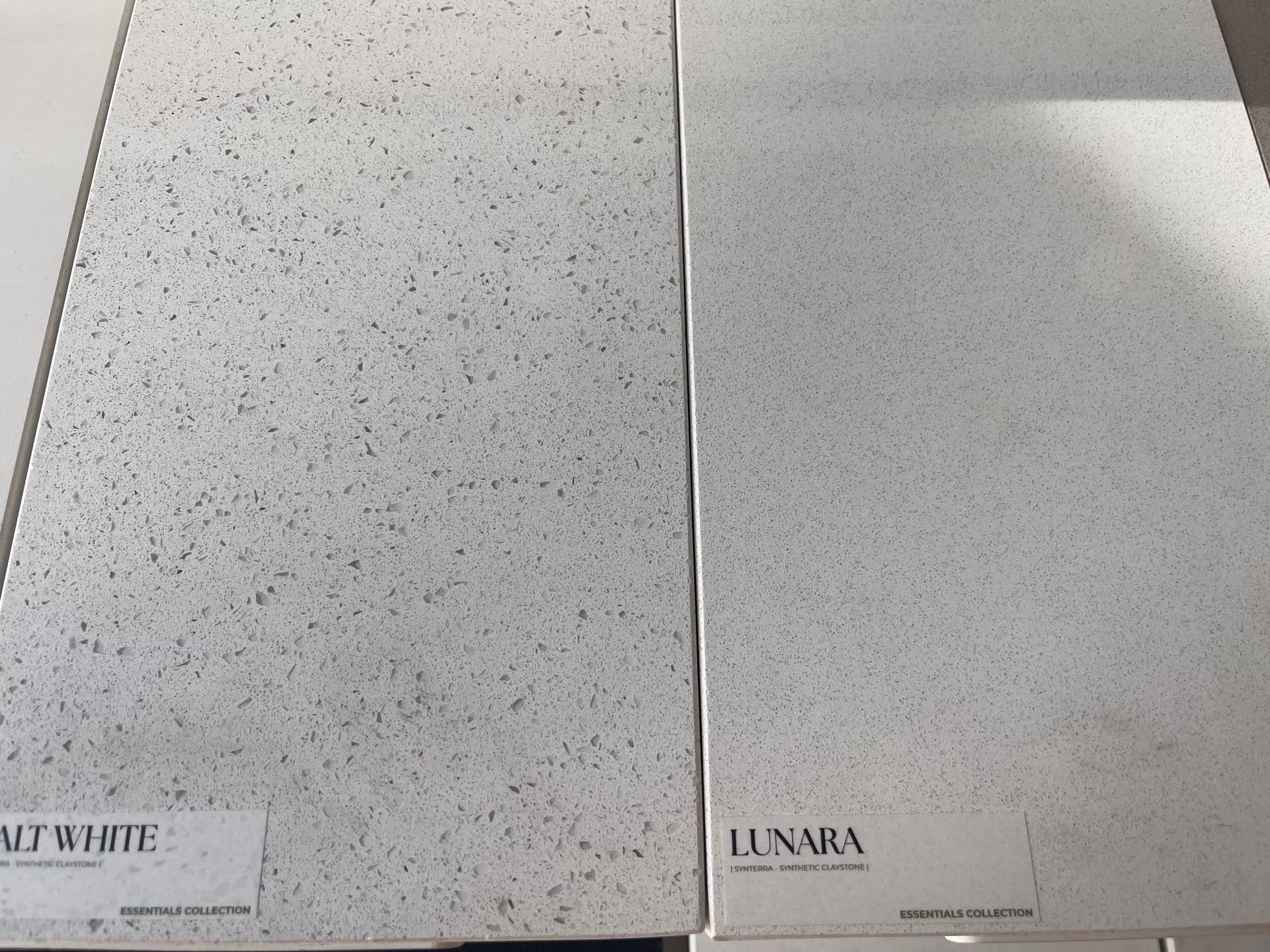 Two white countertop samples: speckled 