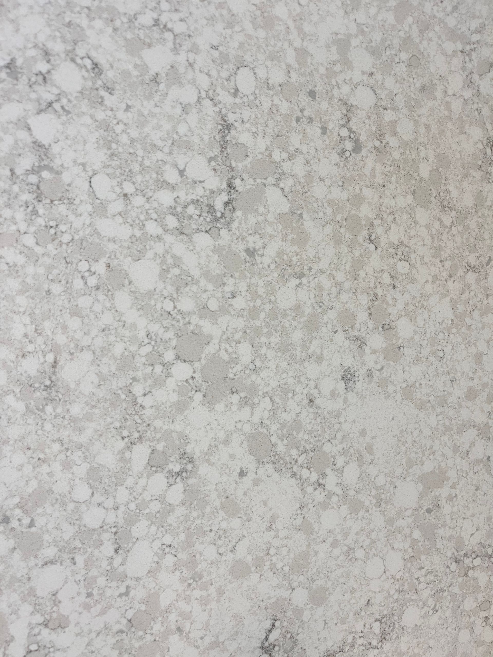 Light gray countertop with speckled pattern and subtle gray veining.
