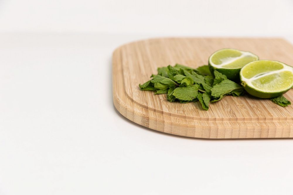 A Wooden Cutting Board With Limes and Cilantro on It — Better Stone in Caloundra West, QLD