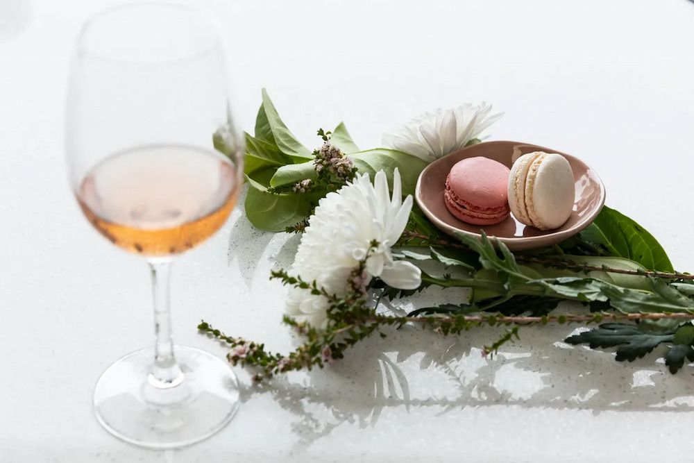 A Glass of Wine, Macarons, Flowers and Leaves on a Table — Better Stone in Caloundra West, QLD