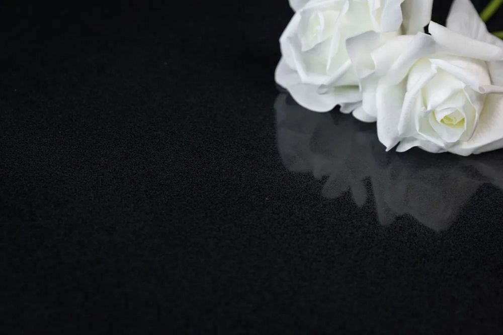 Two White Roses Are Sitting on a Black Surface — Better Stone in Caloundra West, QLD