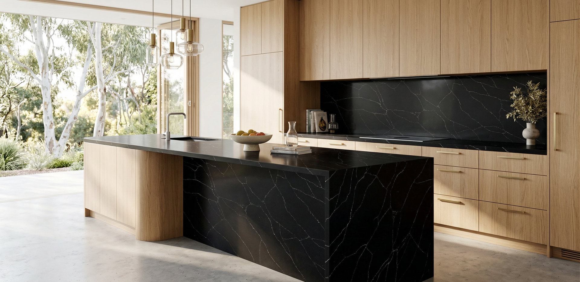 A Modern Kitchen With Light Wood Cabinetry, Black Marble Countertops and Backsplash — Better Stone in Caloundra West, QLD
