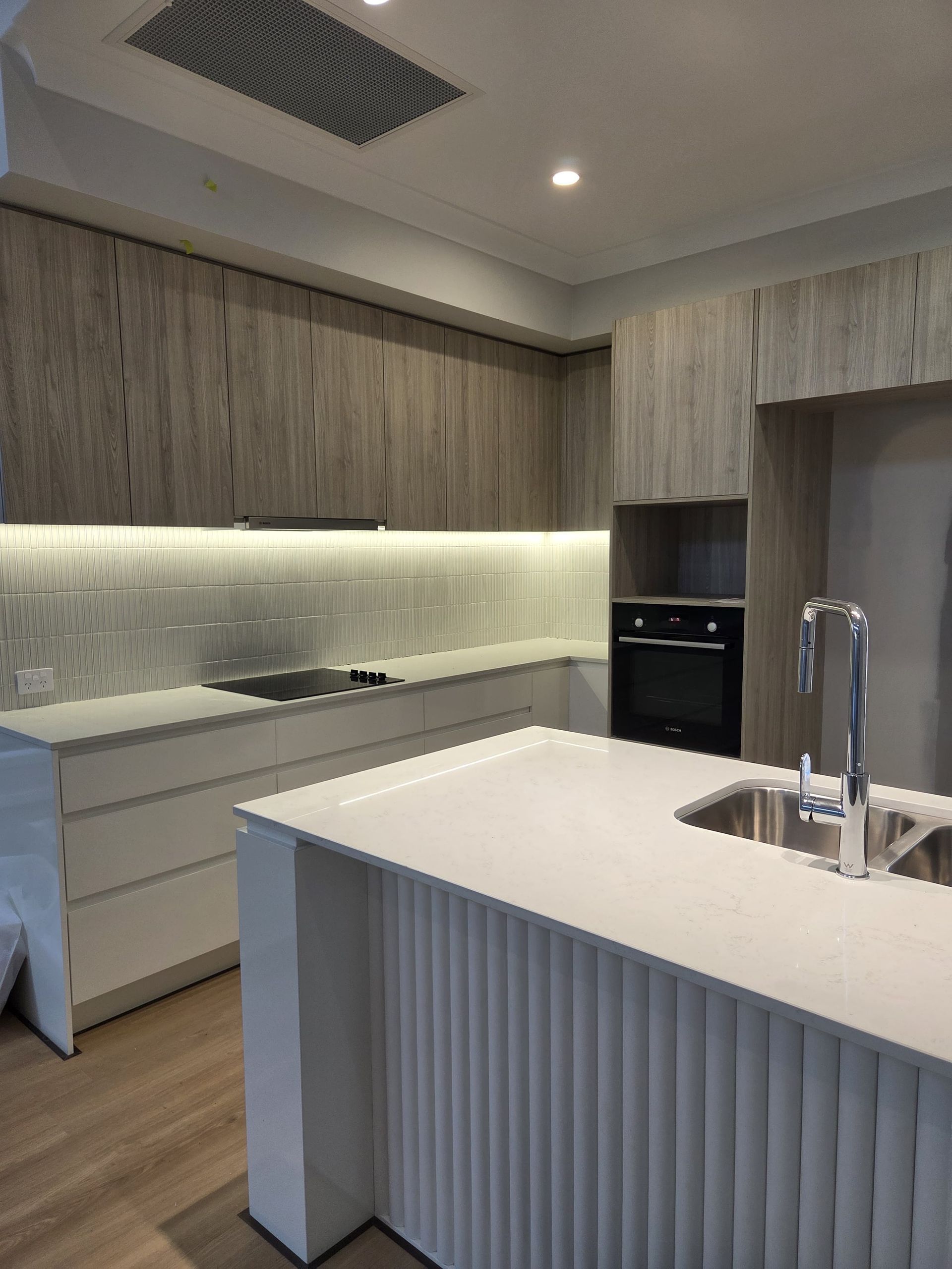 A Modern Kitchen With Light Wood-grain Cabinetry — Better Stone in Caloundra West, QLD