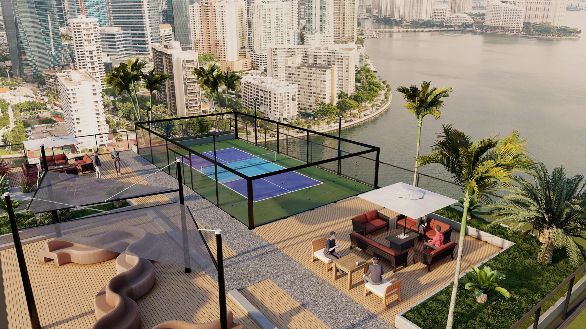 An aerial view of a tennis court on top of a building overlooking a body of water.