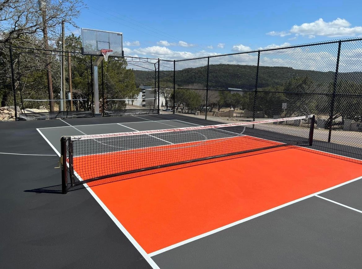 A blue and green tennis court with a white line