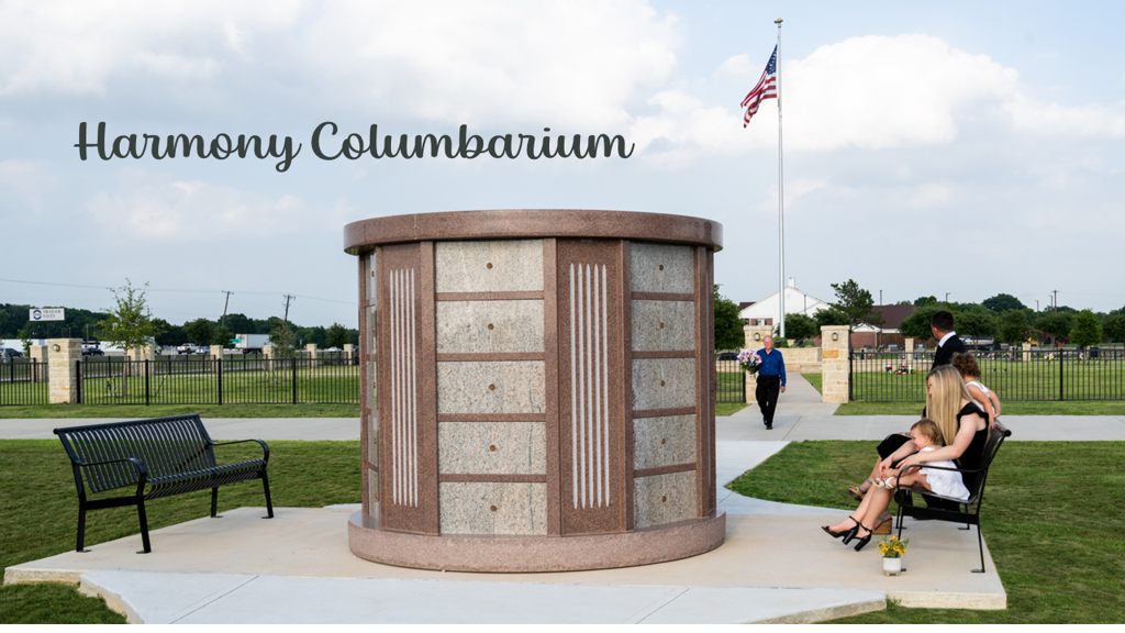 A columbarium in New Hope Memorial Gardens with a family sitting beside it