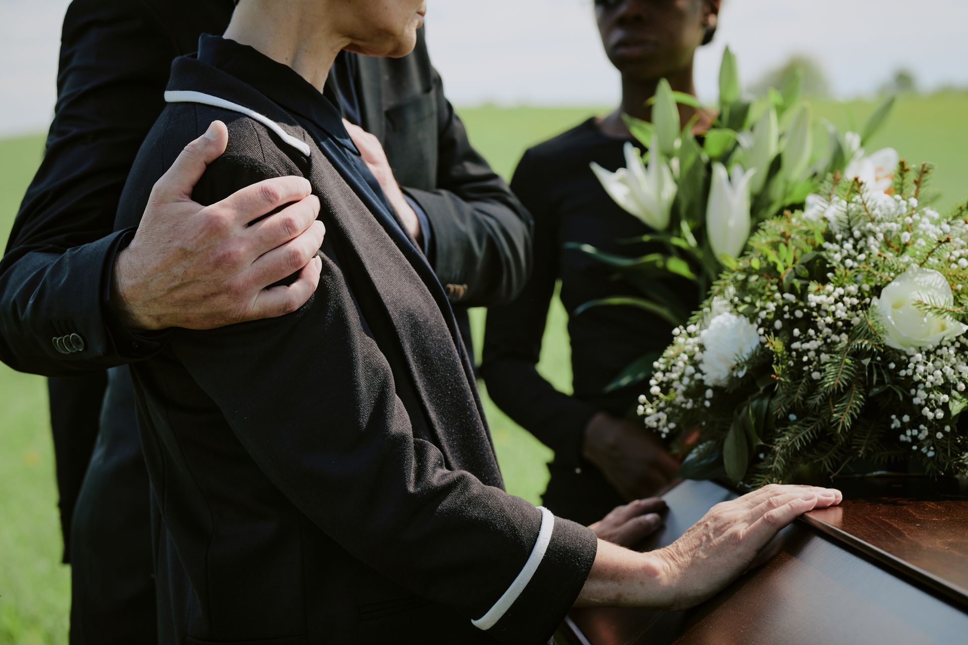 A family next to a casket at a funeral
