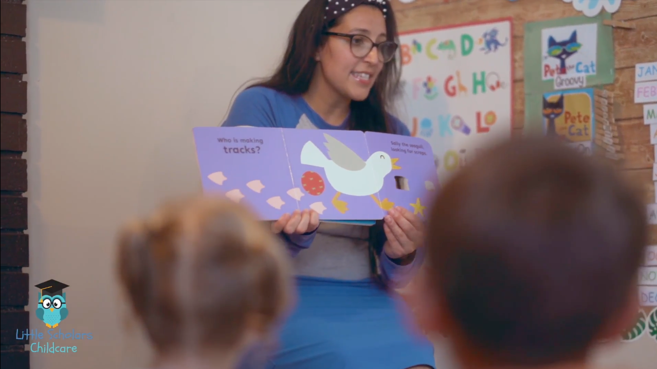 A woman is reading a book to a group of children