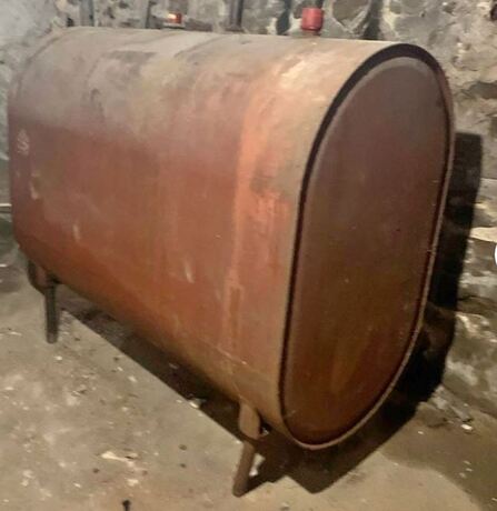 old oil tank beside the wall