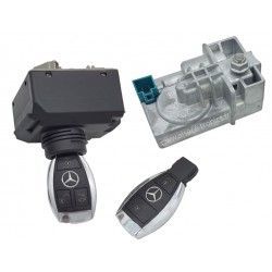 Mercedes car key and black key fob next to a gray ignition switch housing, shown on white background