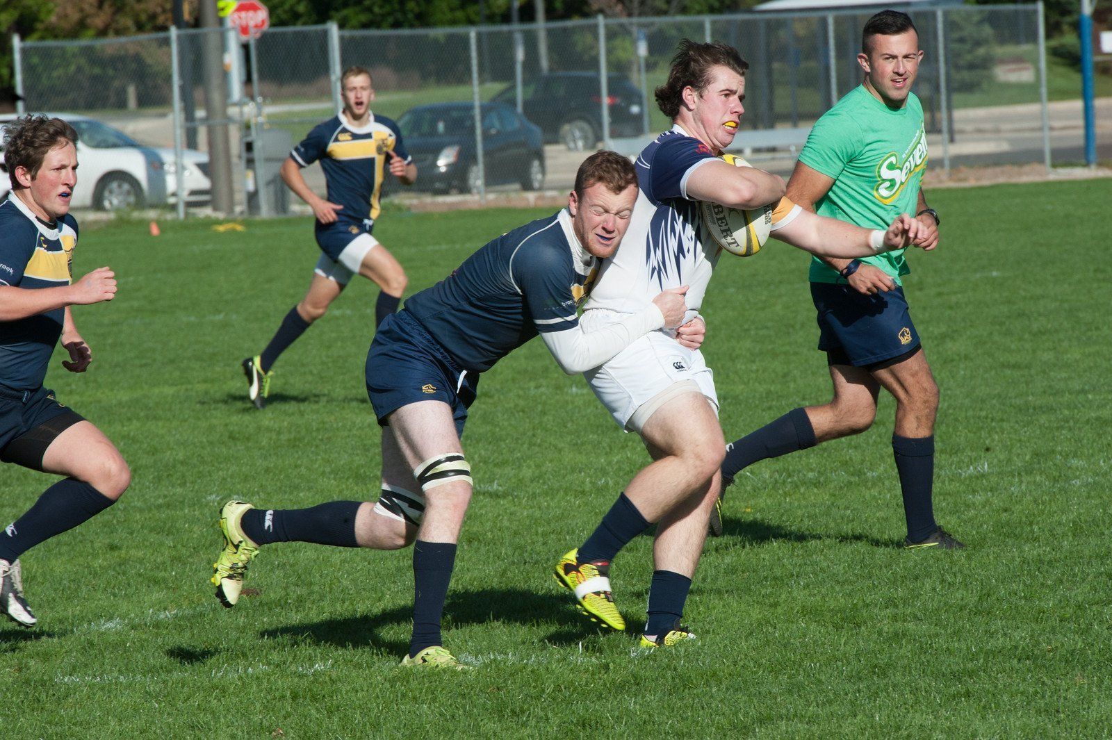 A group of men are playing rugby on a field.