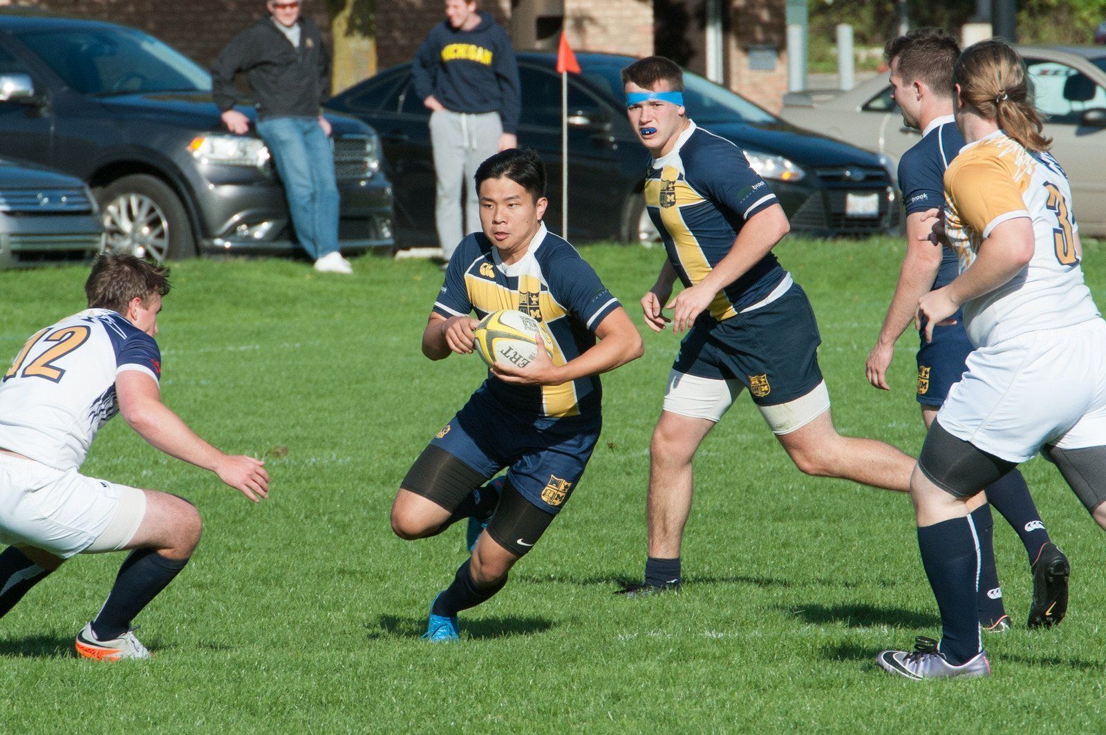 A group of young men are playing rugby on a field.