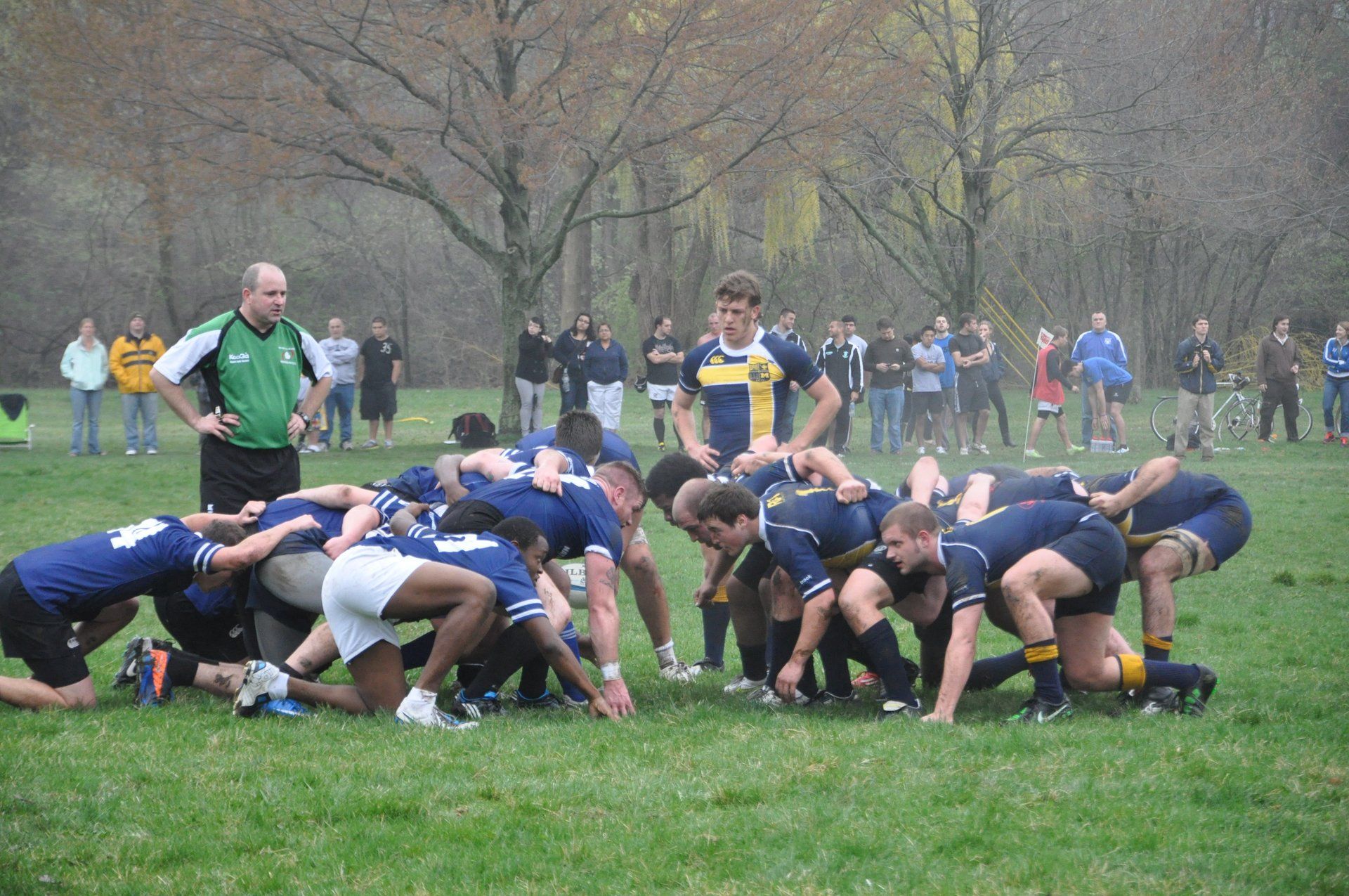 A group of rugby players are huddled together on a field