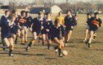A group of people are playing soccer on a field.