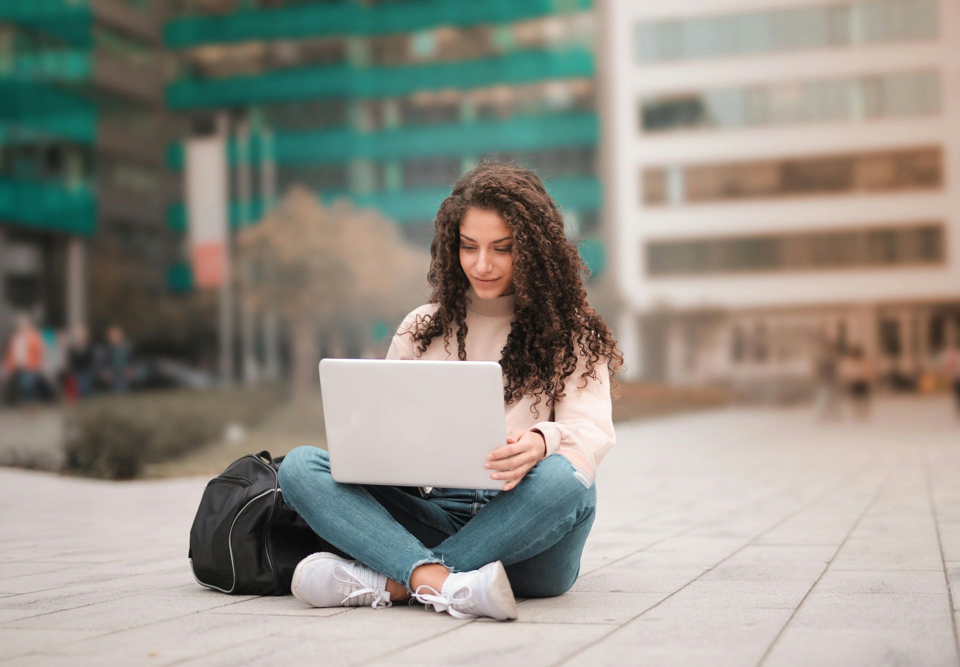 A young woman is sitting at a desk in front of a computer.