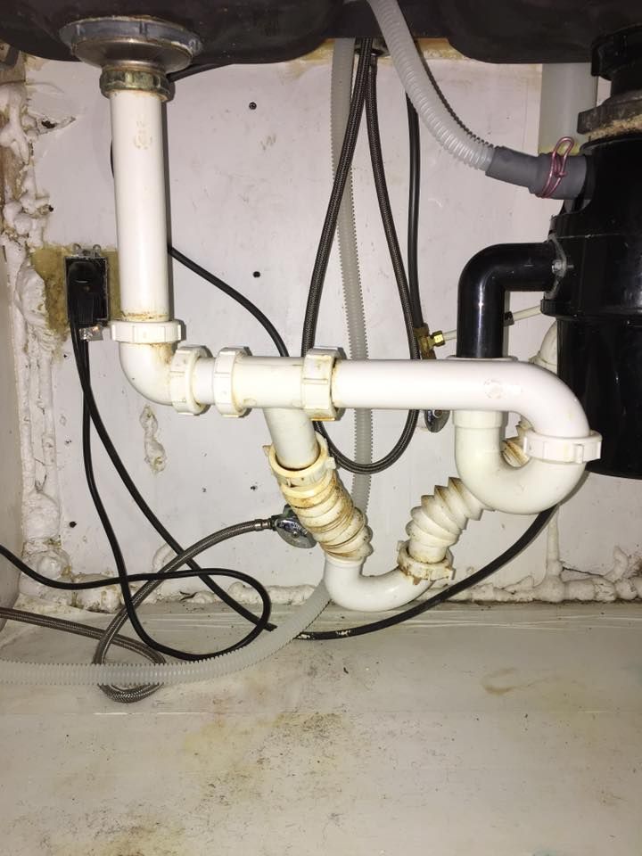 A sink with a lot of wires coming out of it